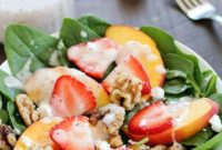 Spinach Salad Featuring Strawberries, Peaches, Candied Walnuts, Goat Cheese, and Poppyseed Vinaigrette