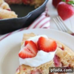 Strawberry Skillet Cornbread 2 This Strawberry Skillet Corn Cake is full of strawberry goodness! It's super easy to make, with only a few ingredients and absolutely perfect to serve for brunch, dessert or a fun snack!