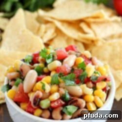 A white bowl is filled with colorful Cowboy Caviar - 43 Healthy Snack Ideas