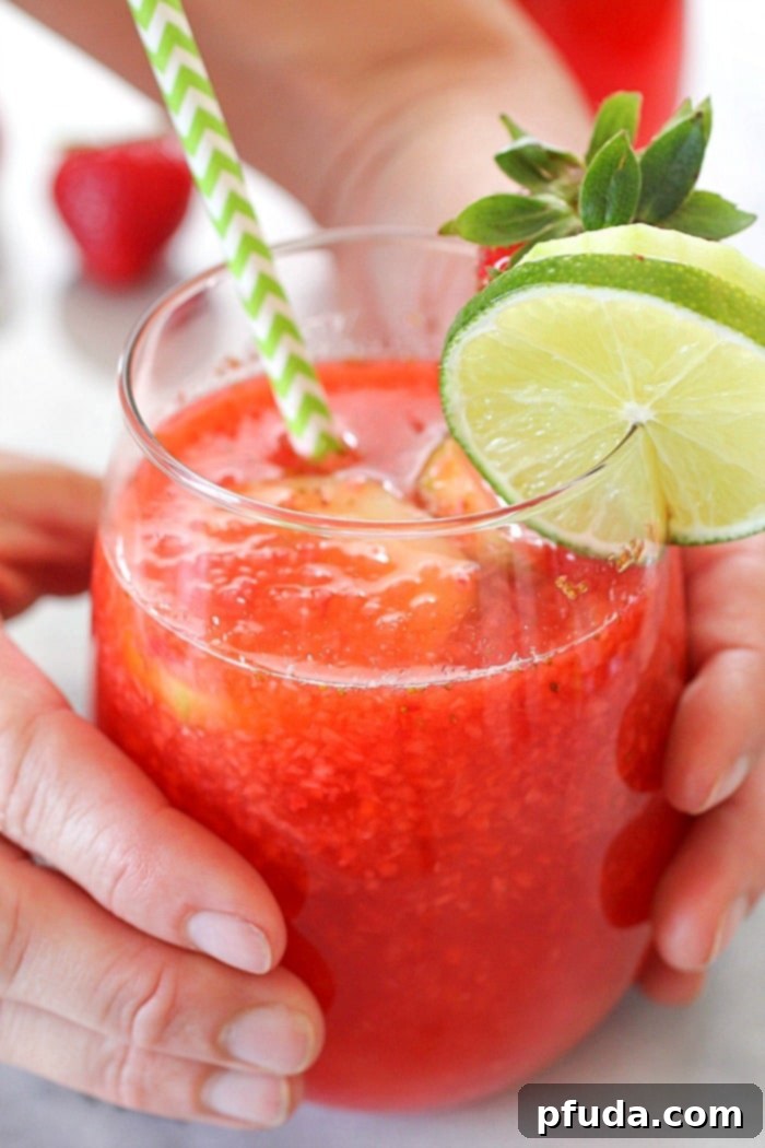 Close-up of fresh strawberries and lime slices, essential ingredients for making homemade strawberry limeade, highlighting the vibrant colors and natural sweetness of the fruit.