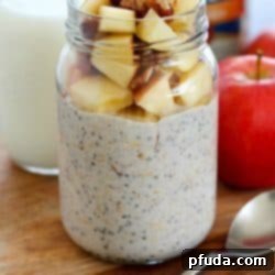 Cozy Apple Pie Overnight Oats 2 Close up of Apple Pie Overnight Oats in a glass jar with toppings
