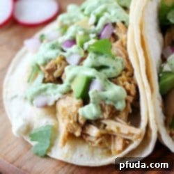 Pork Verde Tacos cooked in the crock pot and served with a drizzle of amazing jalapeño sauce. You will love the flavor in these pork tacos and love how easy they are to make! AD