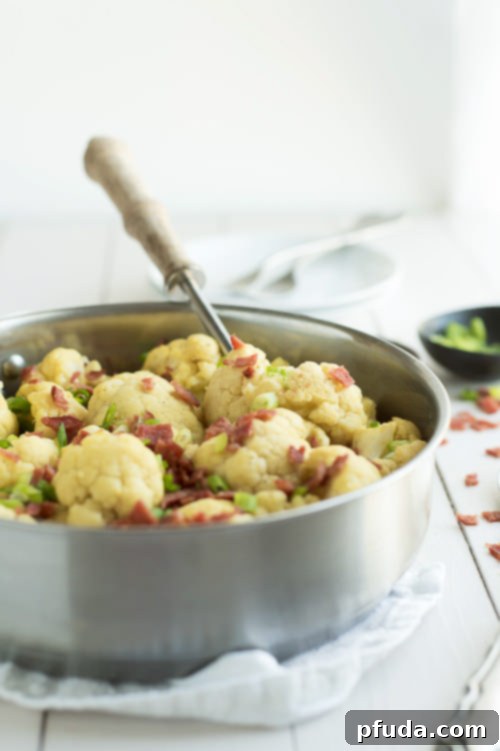 Loaded Cauliflower Mac and Cheese, a guilt-free vegan and paleo version topped with crispy bacon.