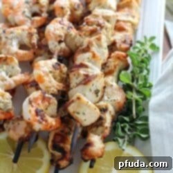 Finished grilled lemon oregano chicken and shrimp skewers ready to serve