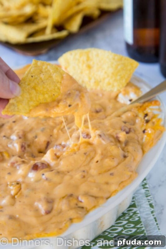 Cheddar Brat Cheese Dip - a warm, gooey cheese dip made with cheddar brats for so much extra flavor! Game day just got better!
