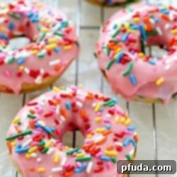 Baked Funfetti Donuts aka Birthday Donuts! These homemade donuts are made with healthier ingredients and baked. Topped with an easy glaze and funfetti sprinkles! Every bite has funfetti sprinkles!