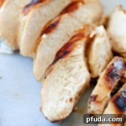 Delicious grilled chicken breast, perfectly cooked and ready to be served, highlighting its juicy interior.