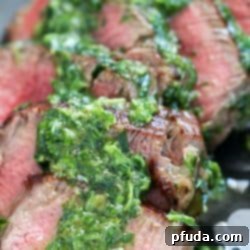 Tender Beef Medallions with Chimichurri Sauce, plated and ready to serve