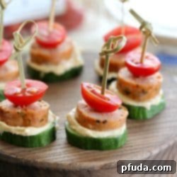 Low Carb Sausage Cucumber Bites skewered with toothpicks on top of a cutting board, a perfect healthy snack.