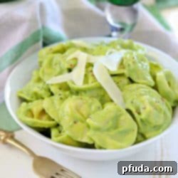 A vibrant square image of Creamy Avocado Tortellini, showcasing the rich green sauce and perfectly cooked tortellini, ready to be pinned.