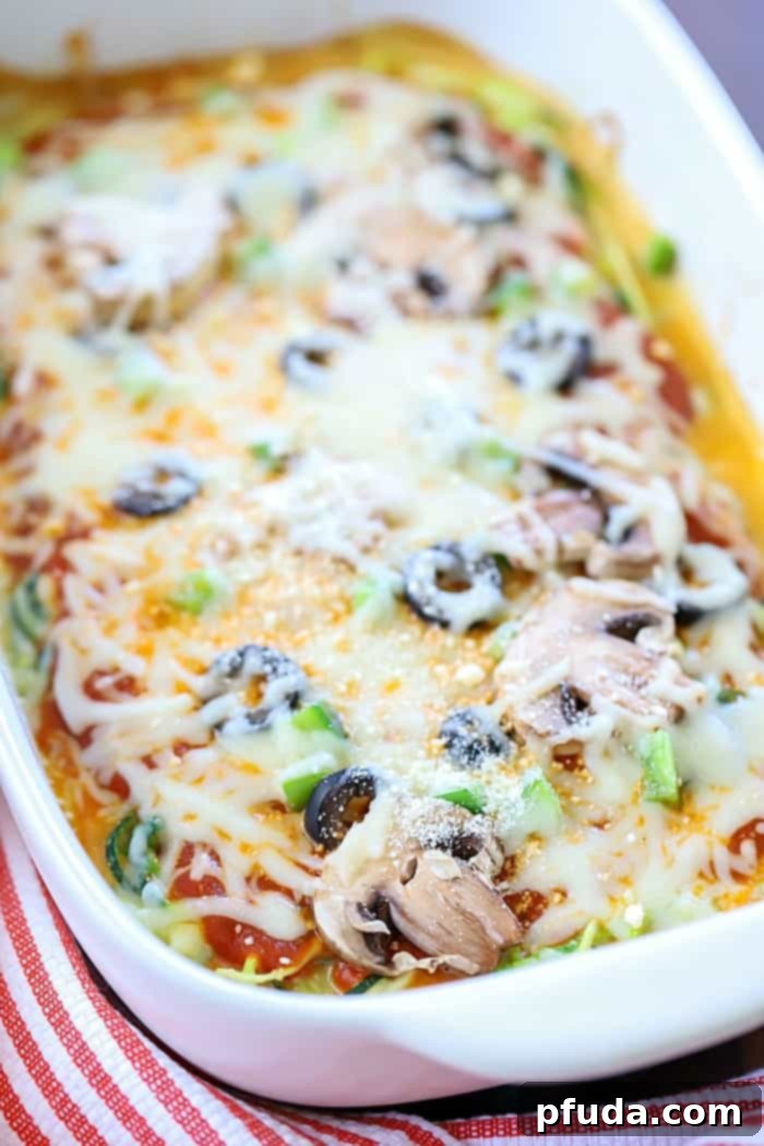 Close-up of freshly baked Zoodle Pizza Casserole, showcasing melted cheese, sauce, and toppings, ready to be served.