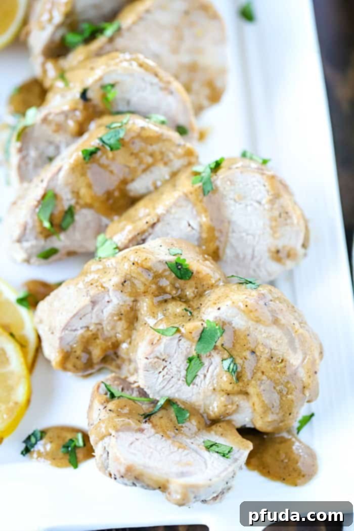 Perfectly baked pork tenderloin slices, glistening with a savory marinade sauce, ready to be served for an easy and delicious dinner.