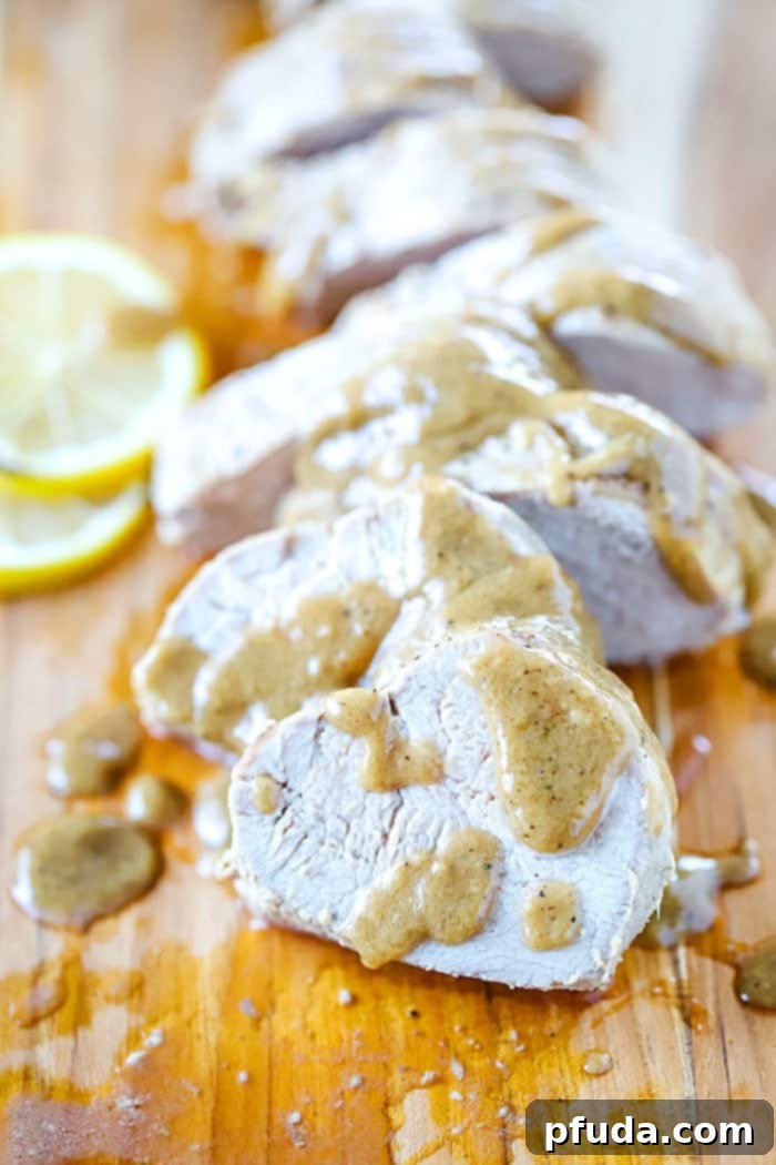 Close-up of perfectly sliced baked pork tenderloin, showcasing its tender texture and the glistening marinade sauce, promising a crazy yummy dinner.