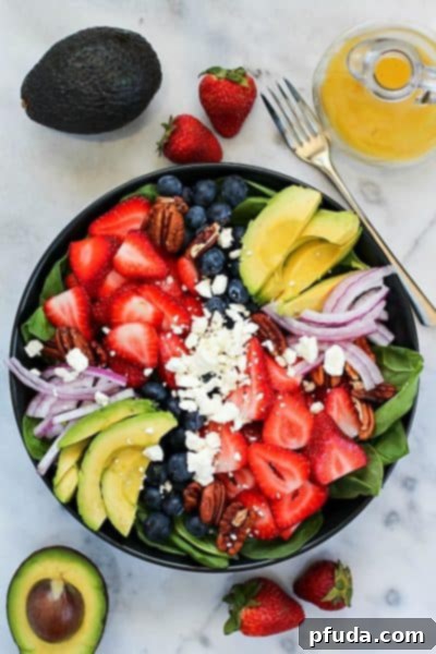 You'll absolutely adore this vibrant Spinach Salad Recipe! Fresh spinach leaves are generously topped with a medley of sweet berries, creamy avocado, tangy feta cheese, crunchy walnuts, and drizzled with a homemade honey-garlic vinaigrette. It's a healthy and flavorful meal!