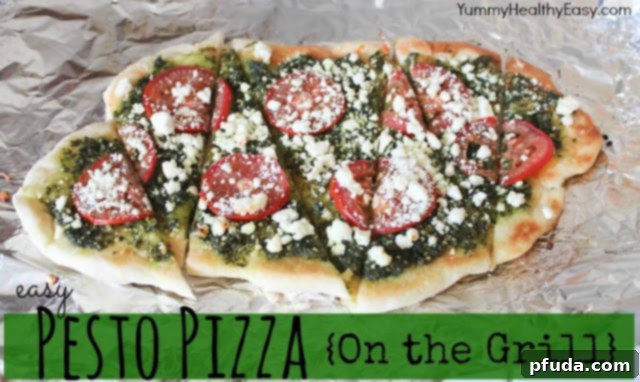 Delicious grilled pesto pizza with a homemade crust, fresh basil, tomatoes, and goat cheese on a wooden board.