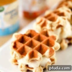 Guilt-Free Waffle Cookie Ice Cream Sandwiches 3 Homemade waffle ice cream sandwich with light ice cream, served on a plate, representing a healthier dessert choice.
