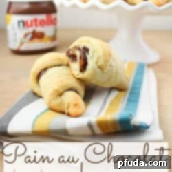 Freshly baked chocolate crescent rolls cooling on a wire rack.