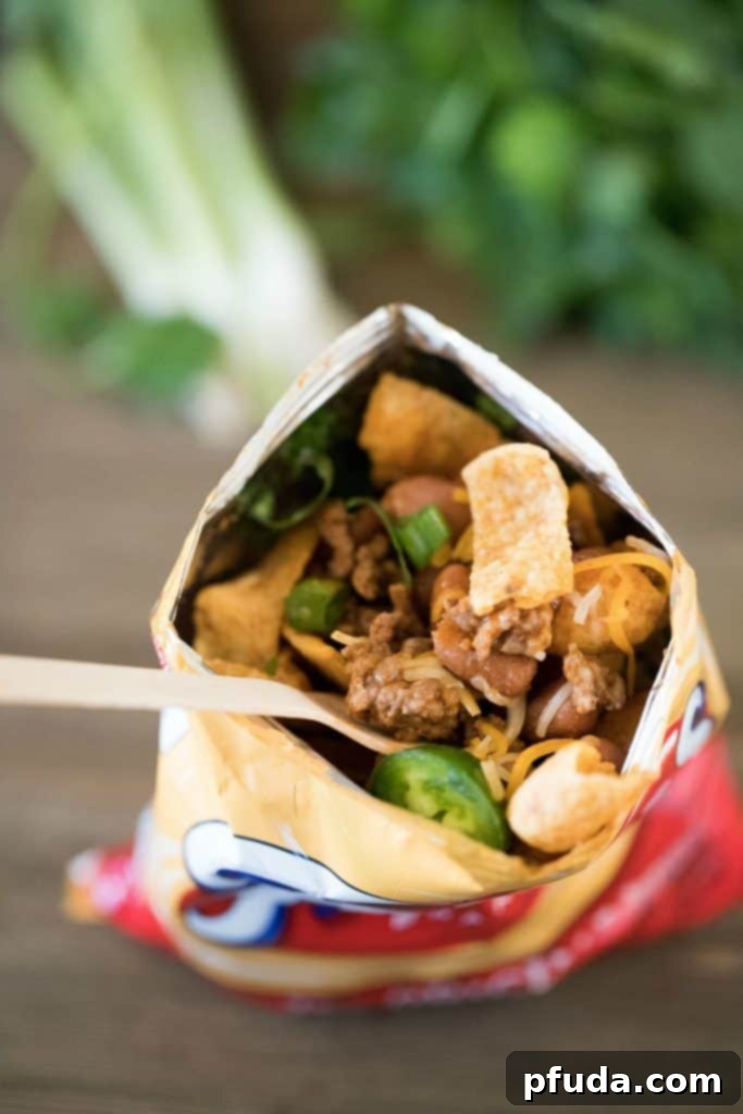 Stride and Savor Frito Pie 3 Top view of a Frito's bag filled with taco filling and toppings.