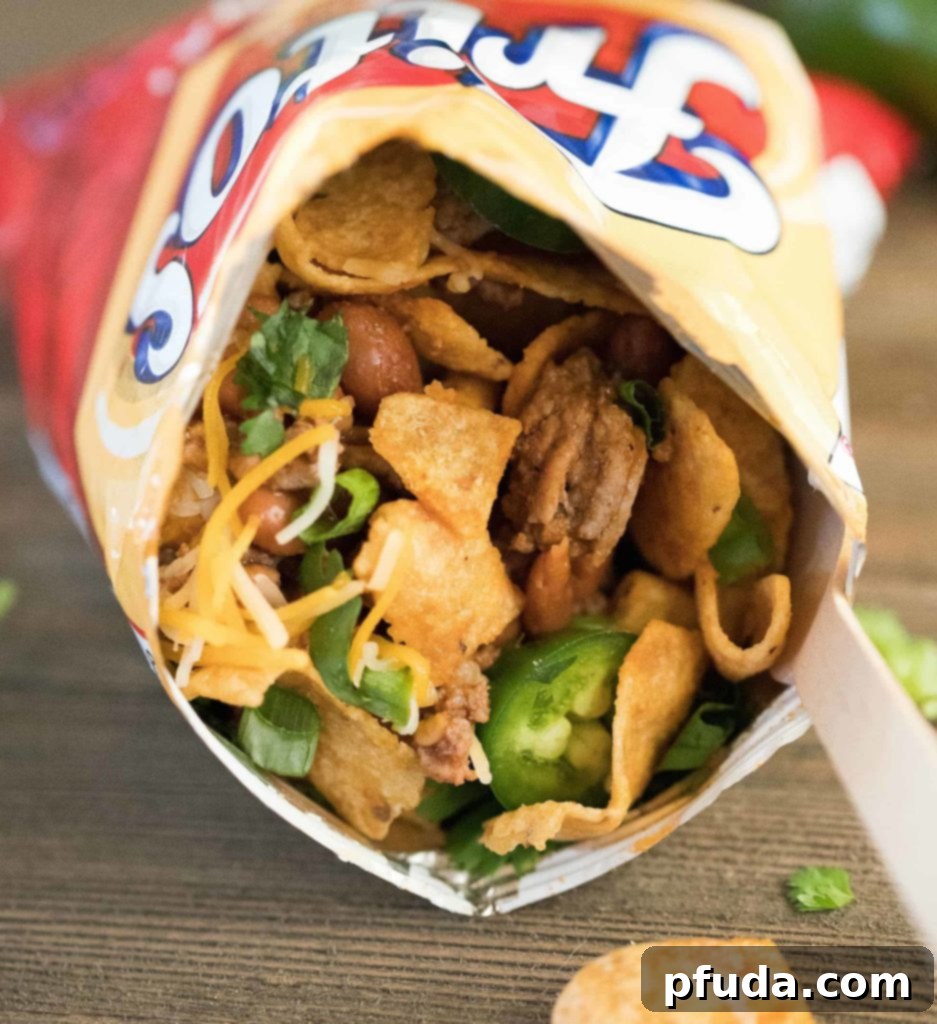 Stride and Savor Frito Pie 4 Close up of a Frito snack size bag filled with taco mixture and toppings. Yum!