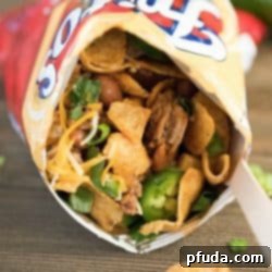 Stride and Savor Frito Pie 5 Close up of a Frito snack size bag filled with taco mixture and toppings. Yum!