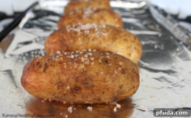 Oven-baked potatoes after cooking, showing their crispy, seasoned skins.