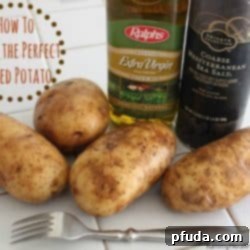 A fully loaded perfect baked potato with butter, sour cream, chives, and bacon bits.