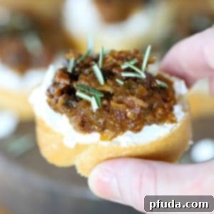 Appetizing layered crostini featuring crispy bread, savory prune bacon jam, and creamy goat cheese.