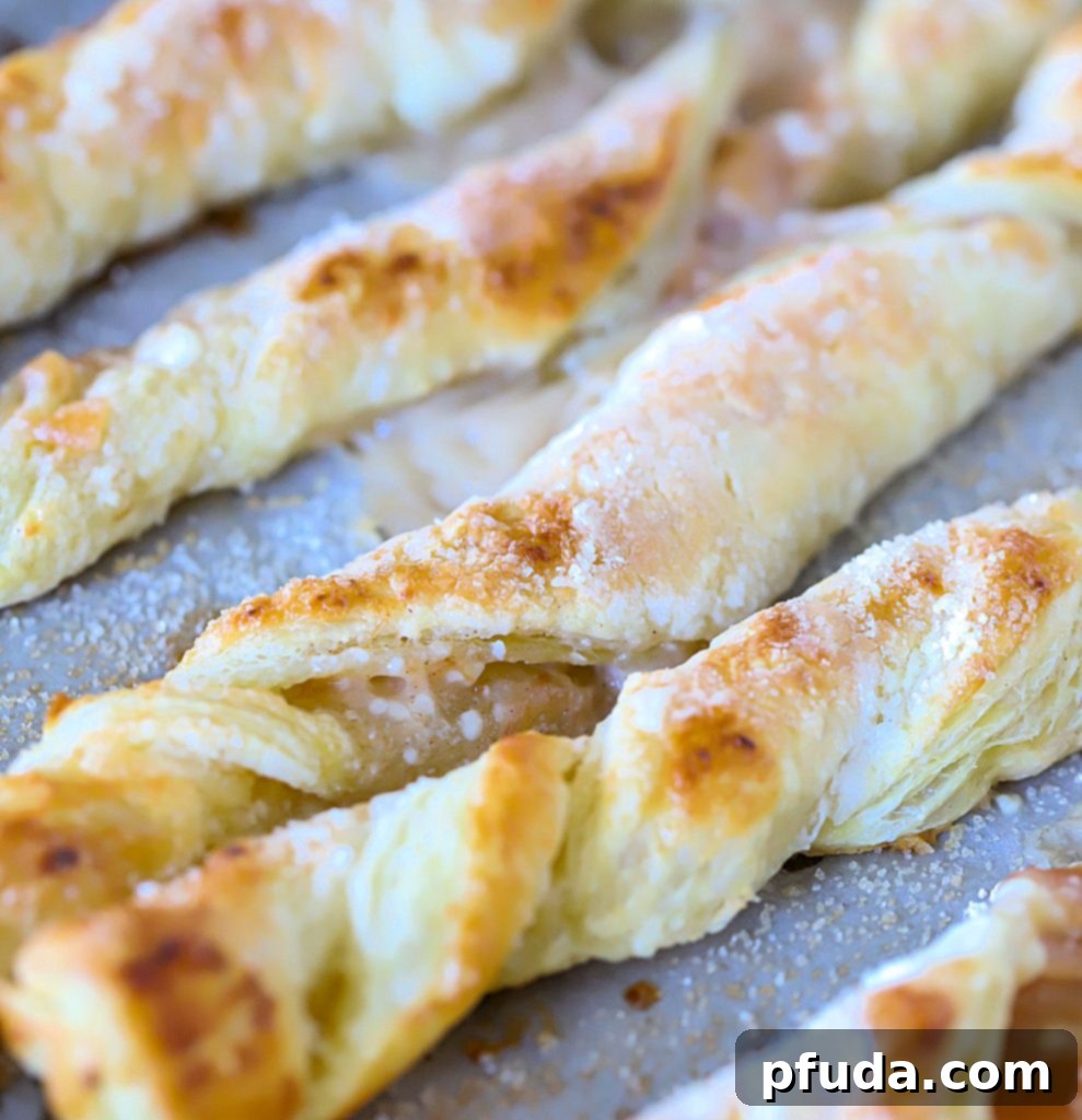 Cinnamon Apple Strudel Spirals 4 Strudel Twists on a baking sheet fresh from the oven.