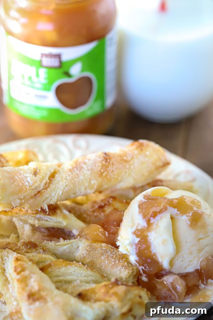 Cinnamon Apple Strudel Spirals 6 A plate full of strudel twists with a side of vanilla ice cream topped with apple pie filling.