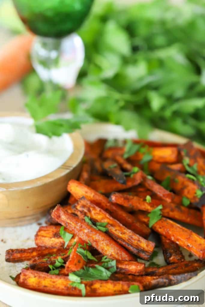 Carrot slices on a plate with a dip on the side.