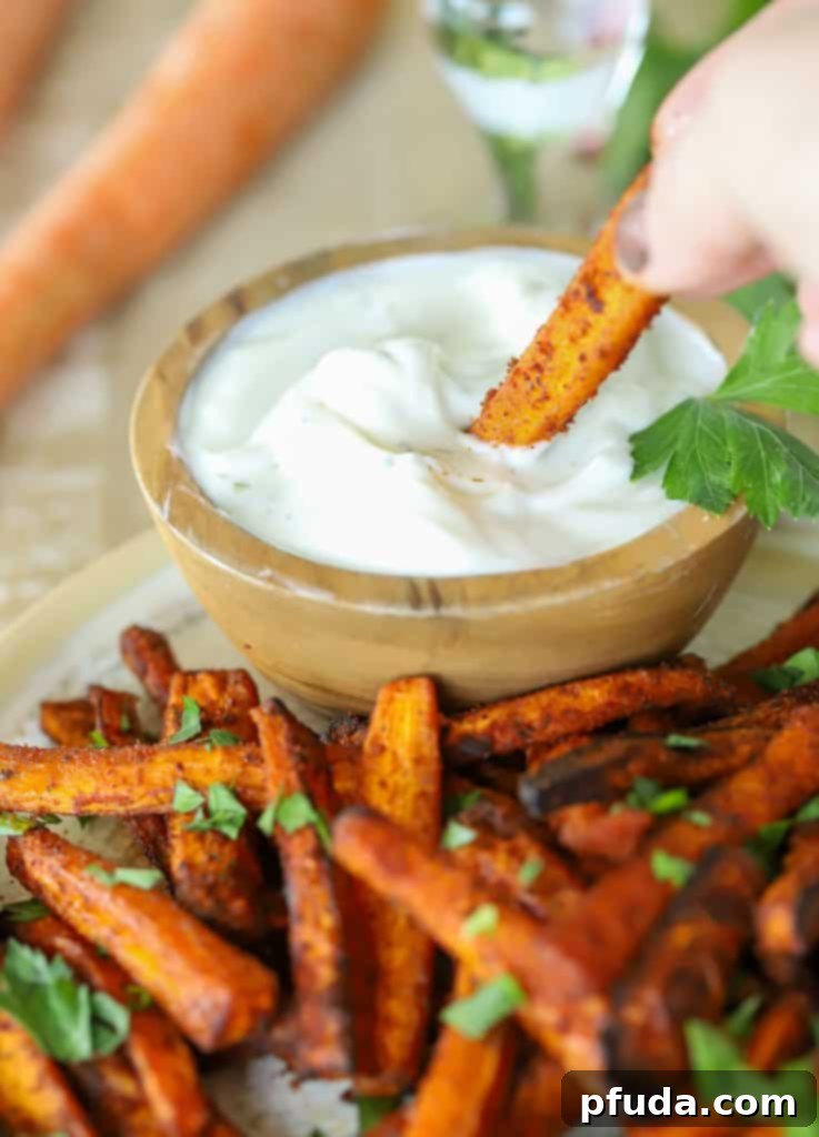 Carrot Fry being dipped in a side sauce.