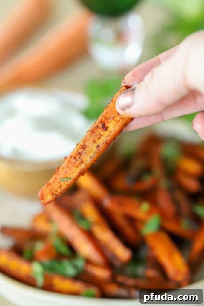 A slice of carrot above a plate.