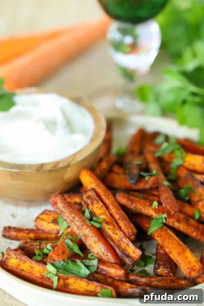 Carrot slices on a plate with a dip on the side.