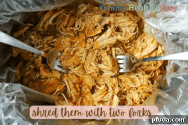 Easy Slow Cooker Low-Sodium Shredded Taco Chicken 7 Crock Pot filled with shredded boneless skinless chicken breasts.