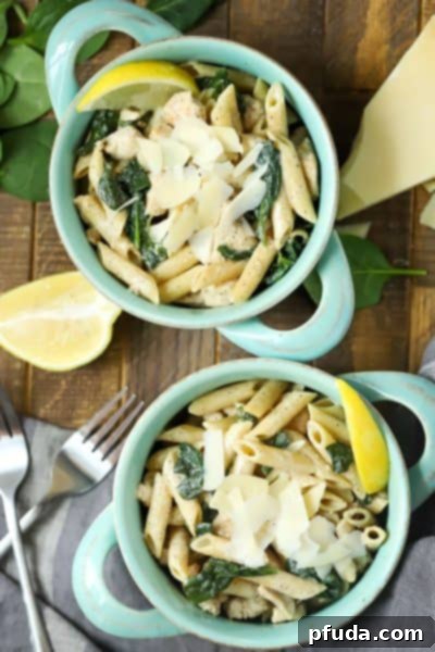 Zesty Lemon Chicken Pasta 4 Top view of chicken lemon pasta (smaller portions) in a white bowl, with a fork.