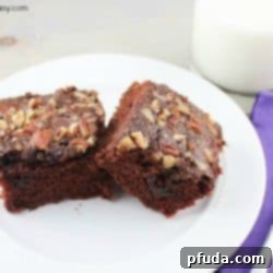 Double Chocolate Snack Cake, garnished with chocolate chips and nuts