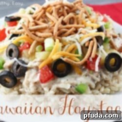 A beautifully plated Hawaiian Haystack with rice, creamy chicken, pineapple, peppers, and cheese.