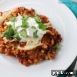 A top-down view of the finished Slow Cooker Chicken Enchilada Casserole, garnished with cilantro.