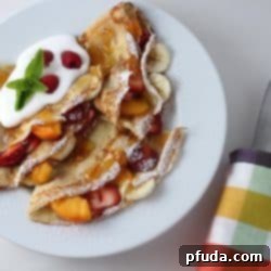 A beautifully stacked pile of golden brown French crepes ready to be served