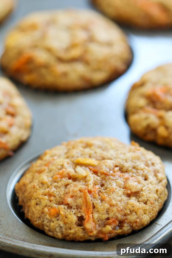 Delicious and healthy Apple Carrot Muffins, also known as Sunshine Muffins, packed with grated carrots, apples, coconut, cinnamon, and nutmeg. Perfect for a fragrant and wholesome family breakfast.