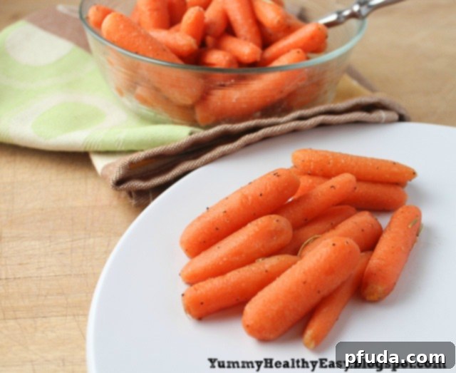 A beautifully plated serving of brown sugar glazed carrots, with a larger bowl of the dish in the background.