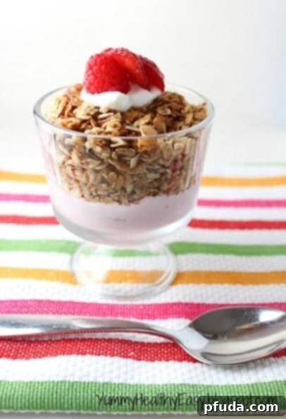 The BEST Homemade Granola Recipe - a delicious bowl of homemade granola with berries and yogurt