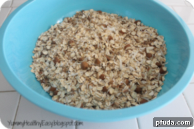 Mixing dry ingredients for granola in a large bowl