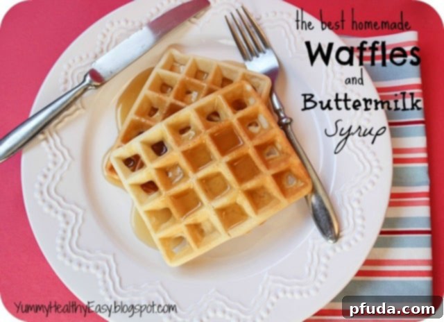 Plate with two fluffy homemade waffles drizzled with homemade buttermilk syrup, ready to eat.
