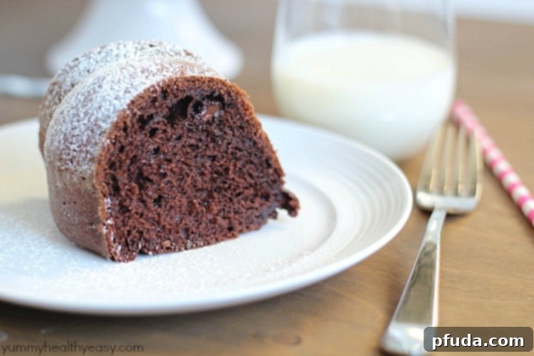 Delicious Skinny Chocolate Bundt Cake, a healthier dessert option. Perfectly moist thanks to applesauce and sugar-free pudding, topped with a dusting of powdered sugar.