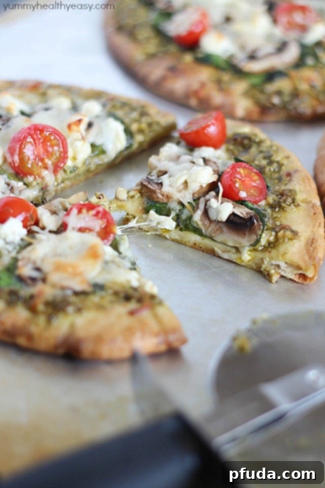 Preparation of a pita pesto pizza with fresh spinach and other toppings