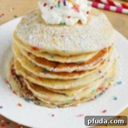 Close-up of a stack of Funfetti Pancakes with sprinkles.
