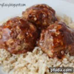 Tangy Glazed Meatballs 2 Delicious Oven-Baked Sweet & Sour Meatballs served over rice, garnished with fresh herbs.