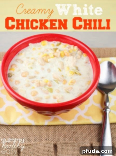 A rich and creamy bowl of white chicken chili, made even more indulgent with a creamy base, topped with fresh herbs.