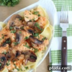 Healthy and creamy chicken stroganoff (made using yogurt) and served over egg noodles.